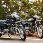 Two Hero commuter motorcycles known for strong fuel efficiency parked on an Indian road