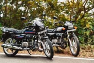 Two Hero commuter motorcycles known for strong fuel efficiency parked on an Indian road