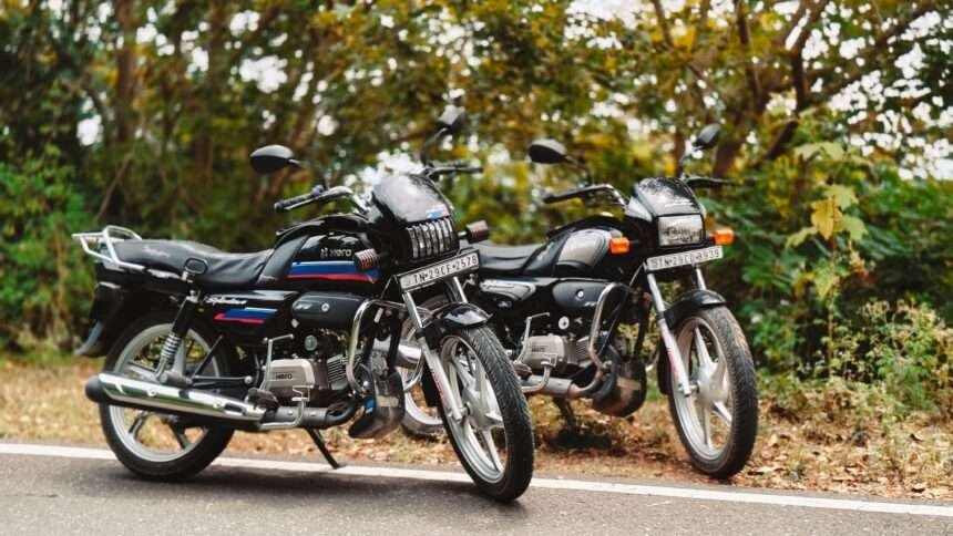 Two Hero commuter motorcycles known for strong fuel efficiency parked on an Indian road