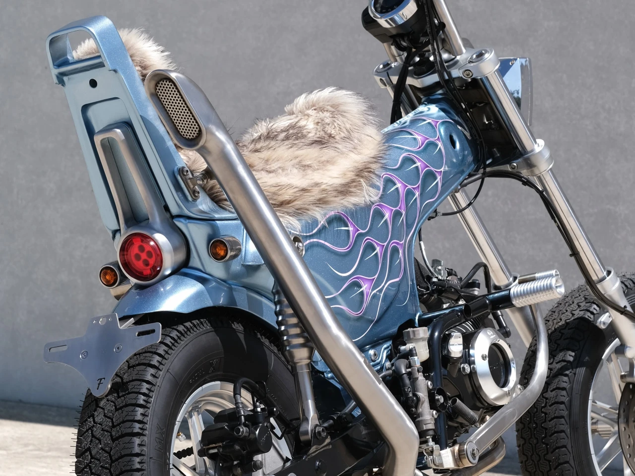 The custom-made stainless steel exhaust pipe is the life of this build