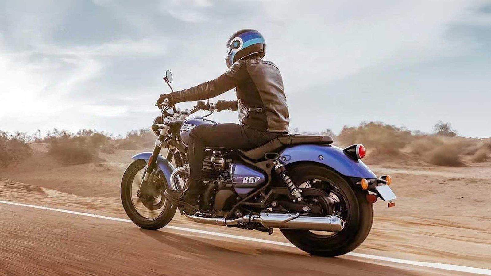 Rear left three quarter action shot of a blue Royal Enfield Super Meteor 650